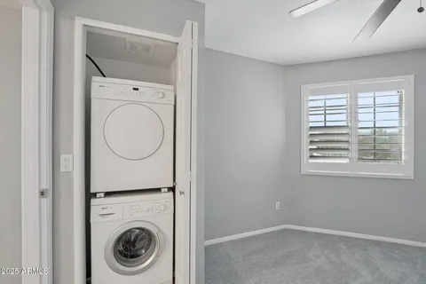 a bathroom with a sink a toilet a mirror and shower