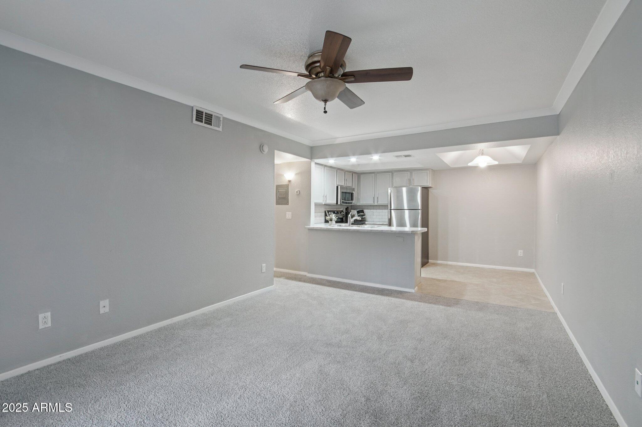 1720 East Thunderbird Road, Unit 2024 Phoenix, AZ 85022 - Photo 3 of 23 a view of a livingroom with a ceiling fan & a ceiling fan