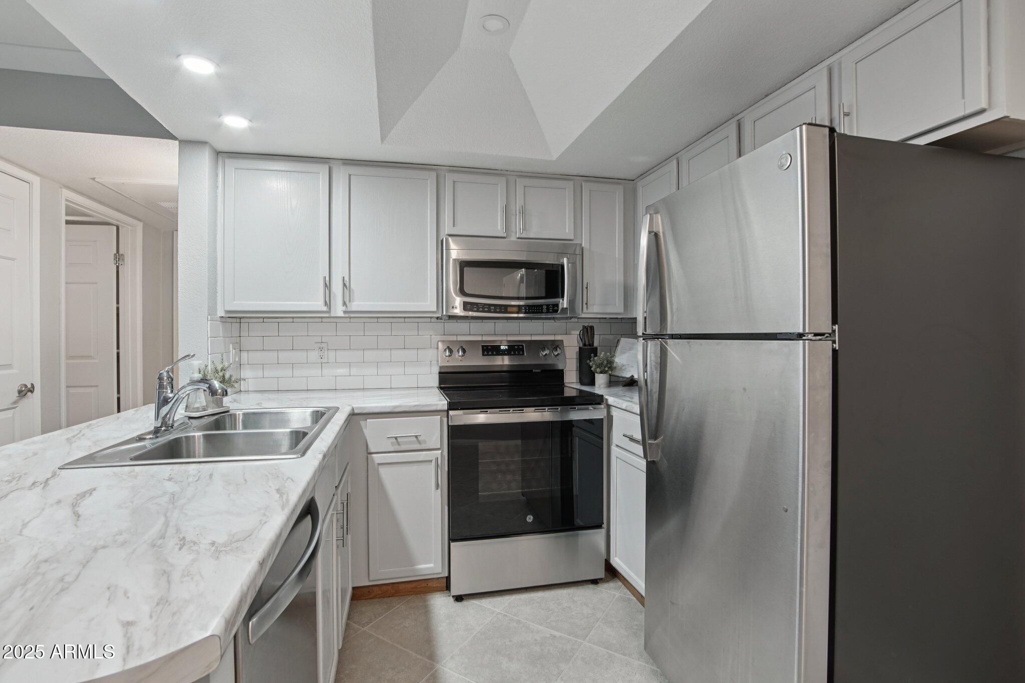 1720 East Thunderbird Road, Unit 2024 Phoenix, AZ 85022 - Photo 4 of 23 a kitchen with a sink and steel stainless steel appliances