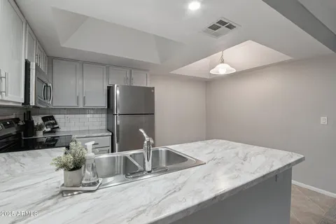 a kitchen with a sink and steel stainless steel appliances