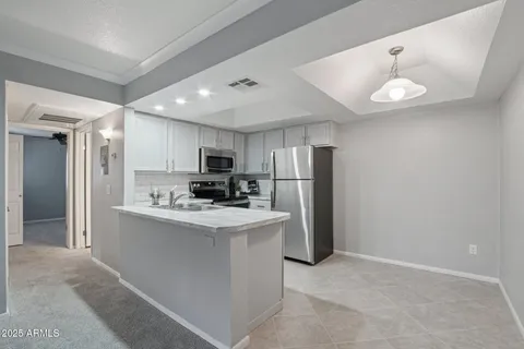 a kitchen with a sink stainless steel appliances and cabinets