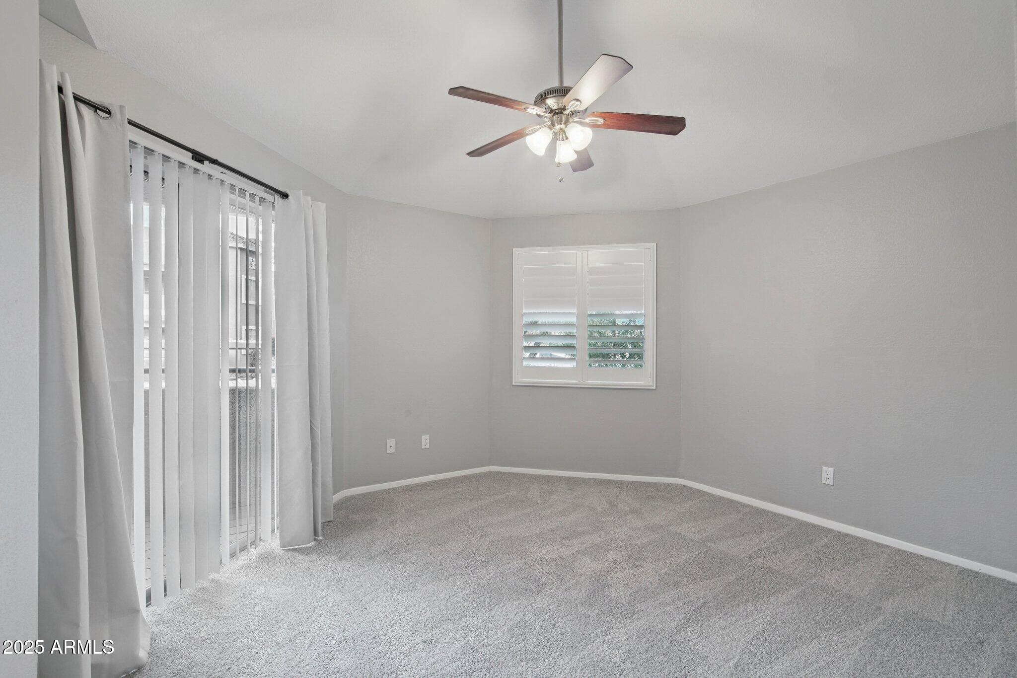 1720 East Thunderbird Road, Unit 2024 Phoenix, AZ 85022 - Photo 8 of 23 an empty room with windows and fan