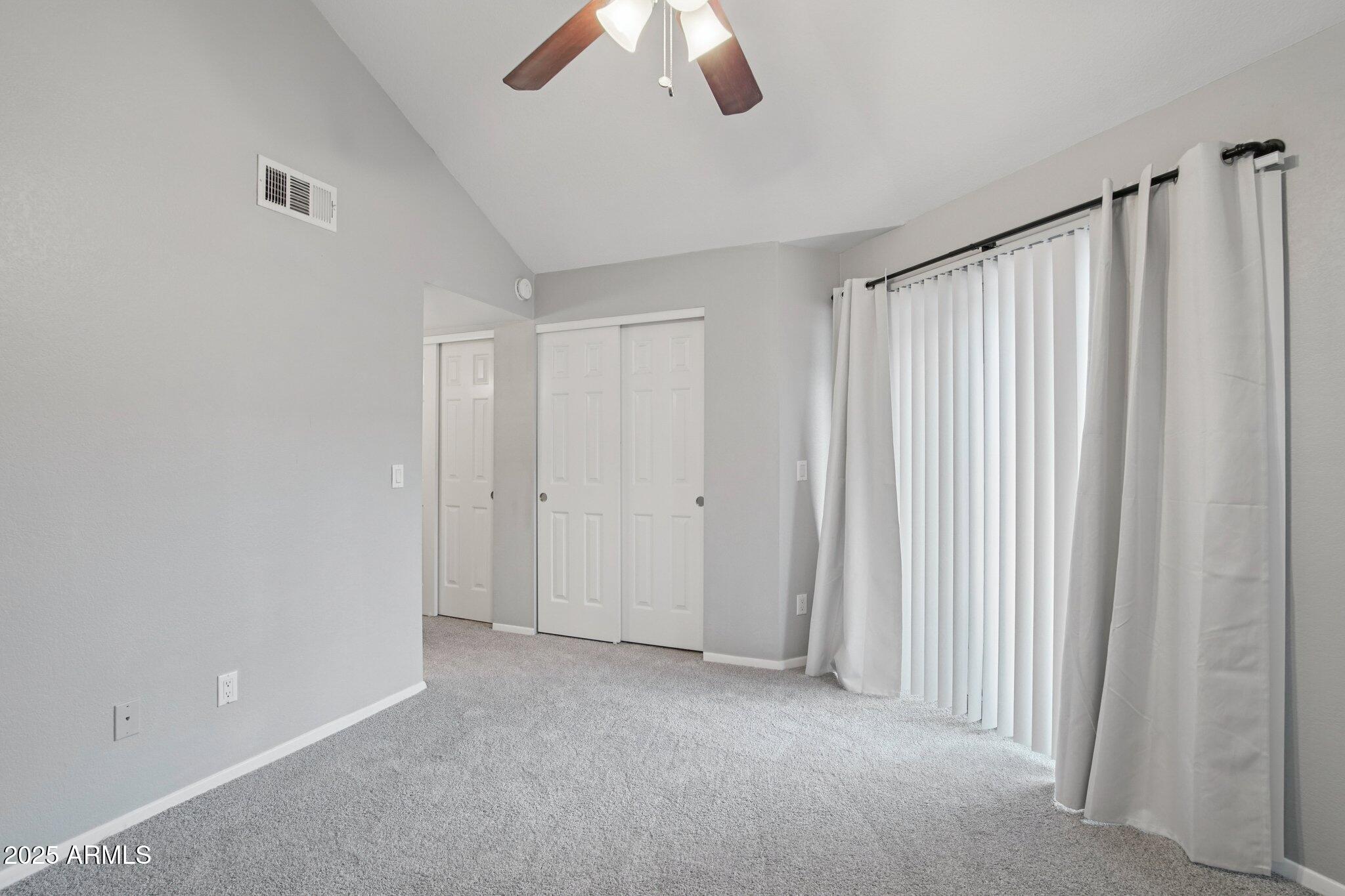 1720 East Thunderbird Road, Unit 2024 Phoenix, AZ 85022 - Photo 9 of 23 a view of a livingroom with a ceiling fan and window