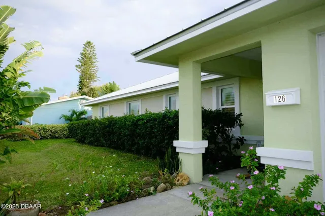 a living room with furniture and a kitchen view