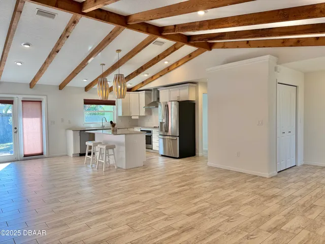 a view of a kitchen with a sink and refrigerator