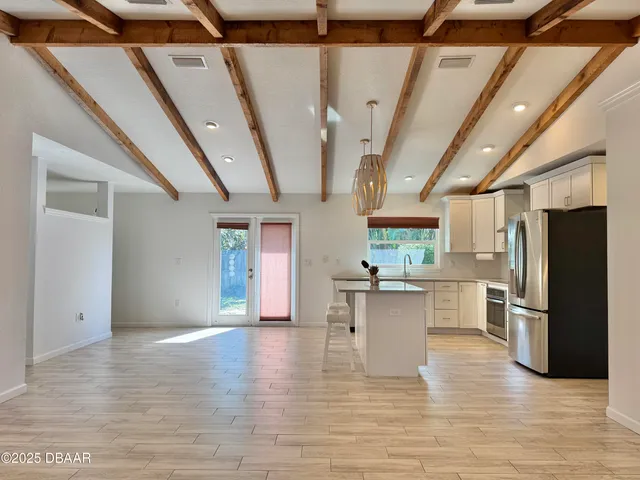 a view of kitchen and dining room with wooden floor