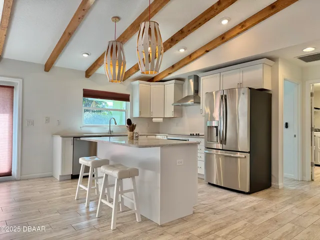 a kitchen with stainless steel appliances granite countertop a sink and a stove
