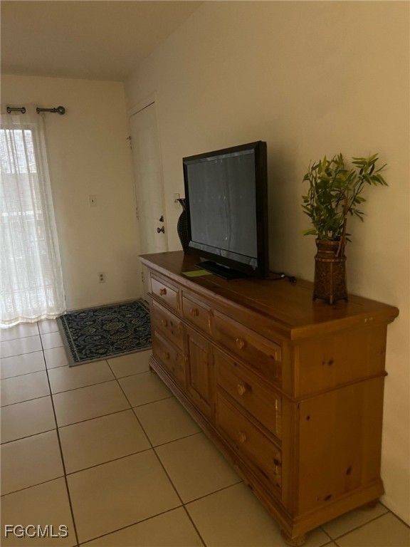 5331 Summerlin Road, Unit 3110 Fort Myers, FL 33919 - Photo 3 of 8 a living room with hard wood floor and a flat screen tv