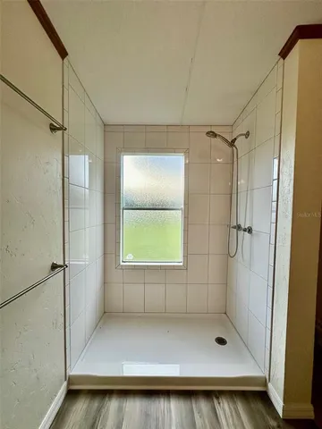 a bathroom with a bath tub and shower
