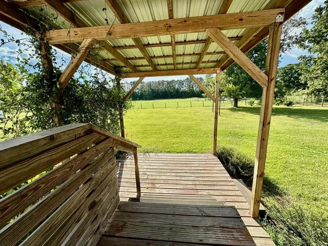 a view of a backyard with sitting area