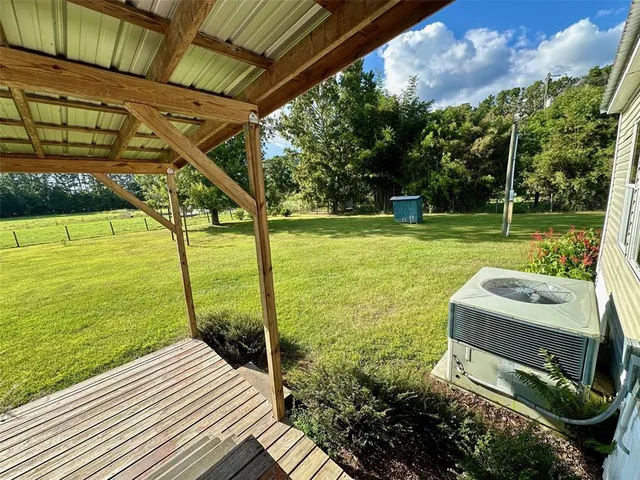 a backyard of a house with lots of green space