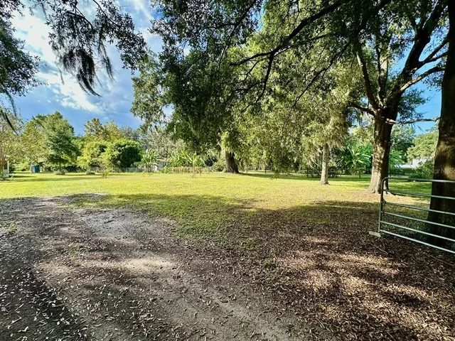 a view of outdoor space with deck and yard