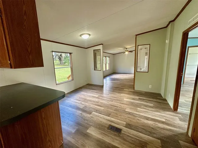 a view of a room with wooden floor and chair