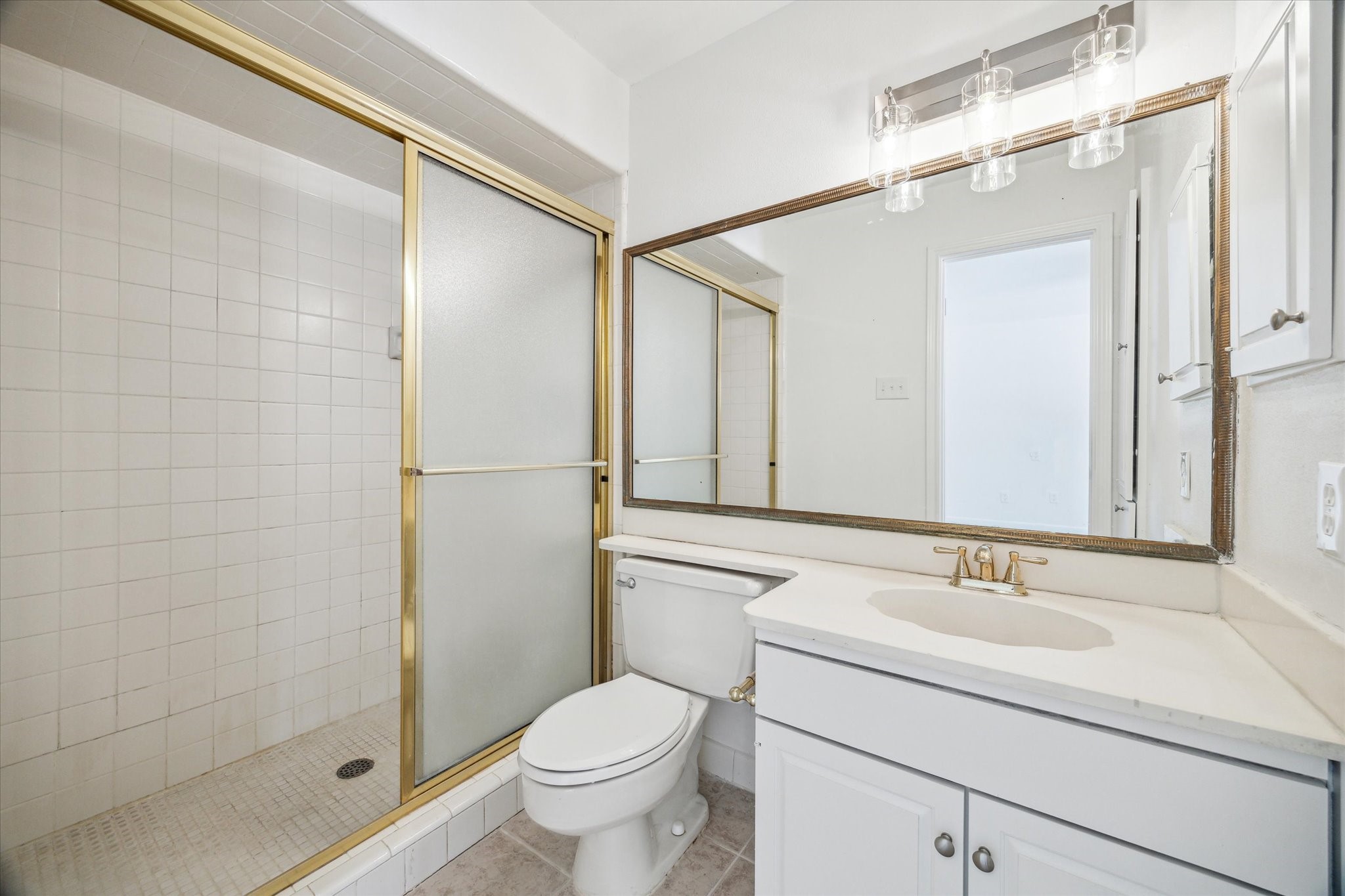 5827 Valley Forge Drive, Unit 83 Houston, TX 77057 - Photo 18 of 25 a bathroom with a sink toilet and shower