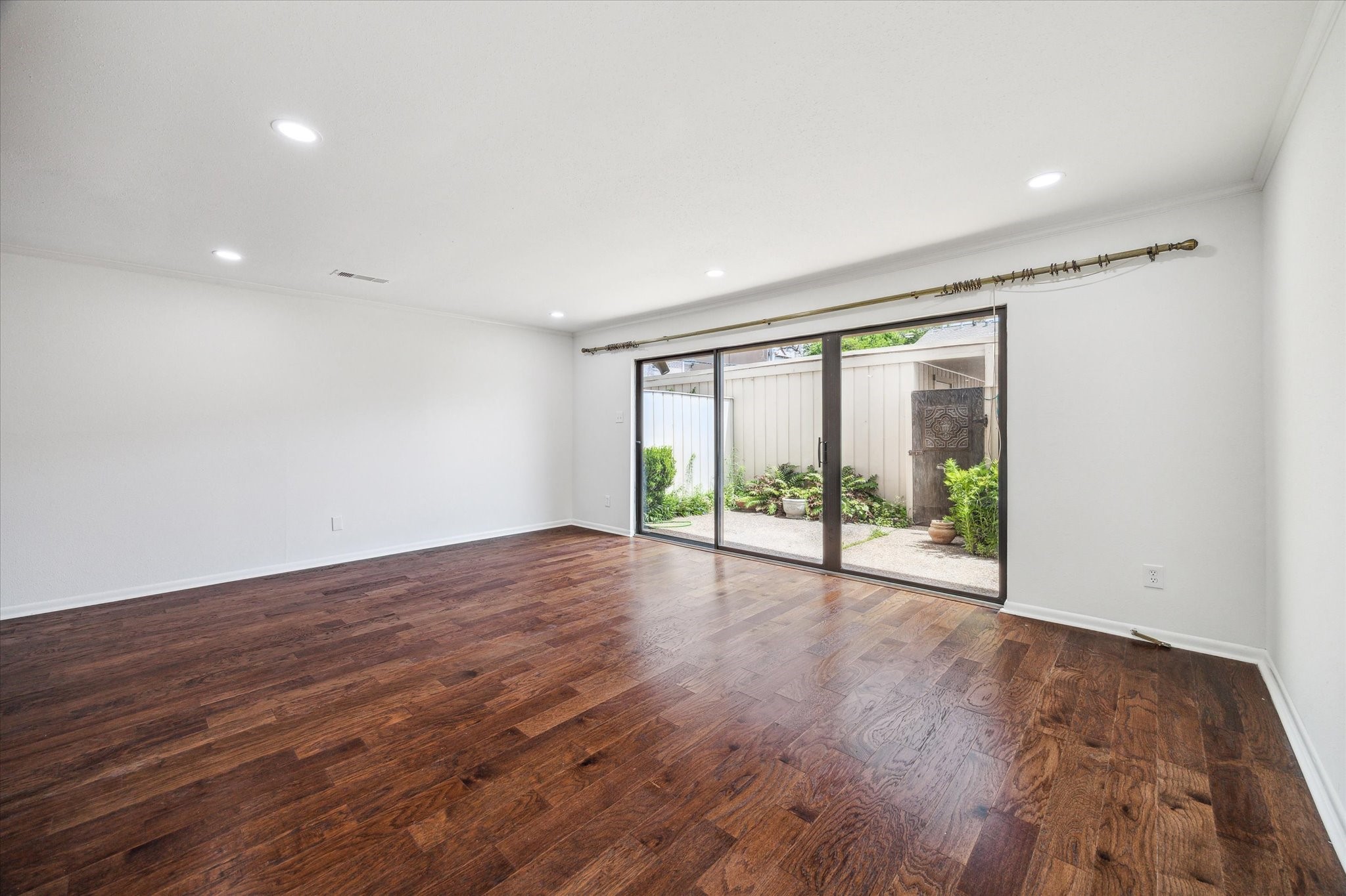 5827 Valley Forge Drive, Unit 83 Houston, TX 77057 - Photo 5 of 25 a view of an empty room with wooden floor and a window