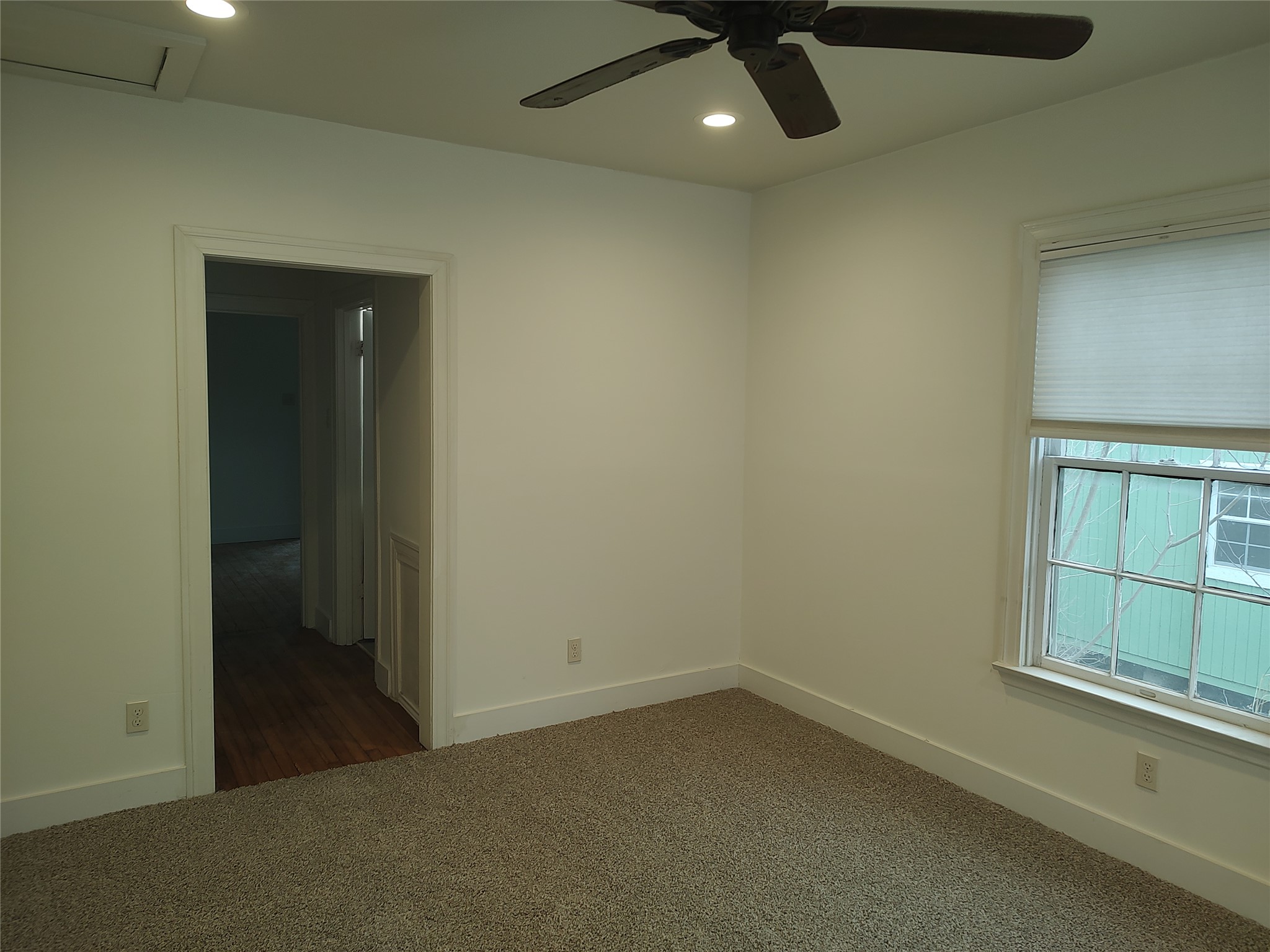 2102 Yellow Jacket Lane, Unit A Austin, TX 78741 - Photo 3 of 15 Unfurnished room with recessed lighting, dark colored carpet, and a ceiling fan