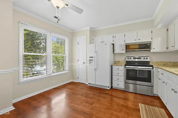 a kitchen with stainless steel appliances a stove sink and microwave