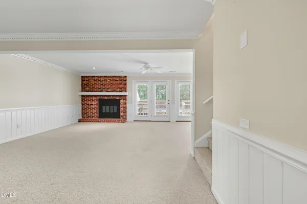 a view of empty room with a fireplace