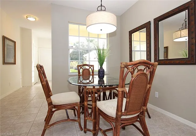 a dining room with furniture a chandelier and window