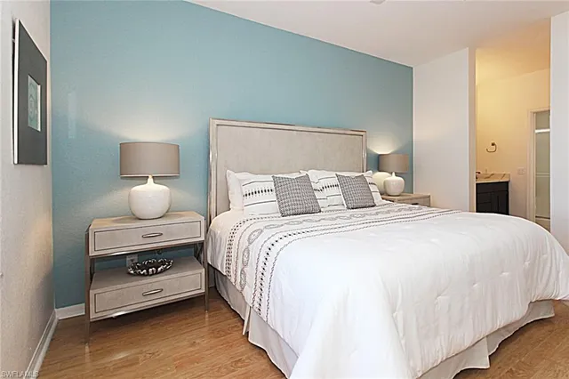 a bedroom with a bed and a lamp