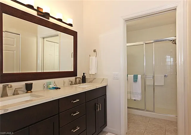 a bathroom with a double vanity sink mirror and