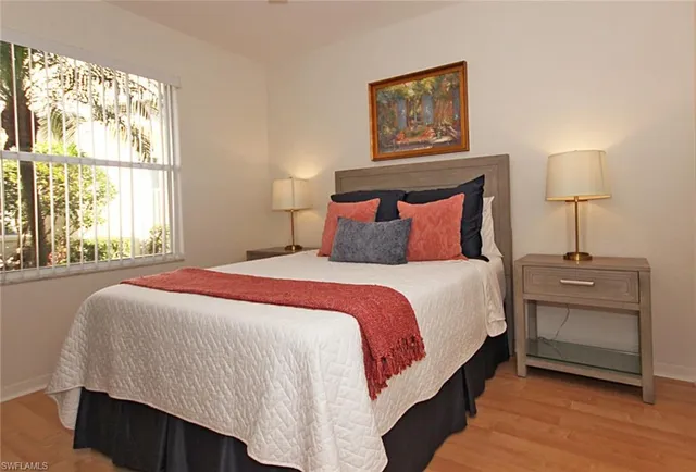 a bedroom with a bed and a night stand