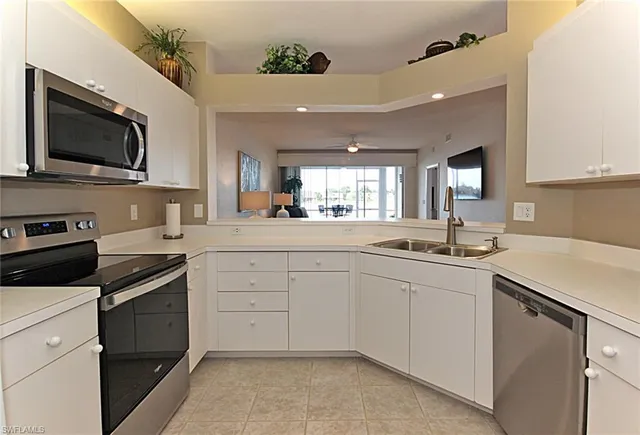 a kitchen with a sink stove and microwave