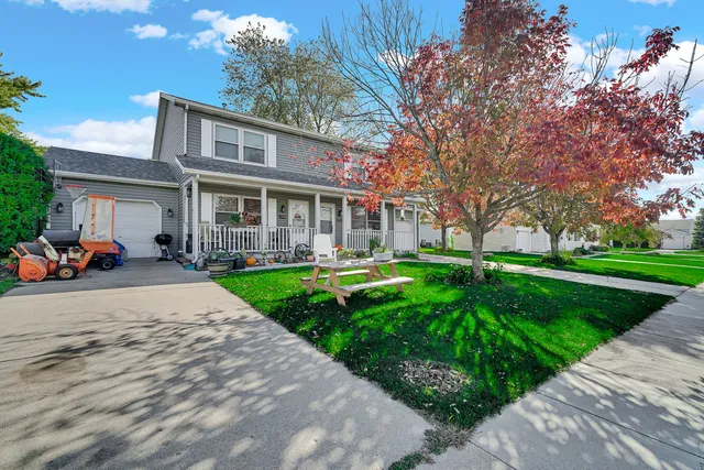 a front view of a house with garden and a garden