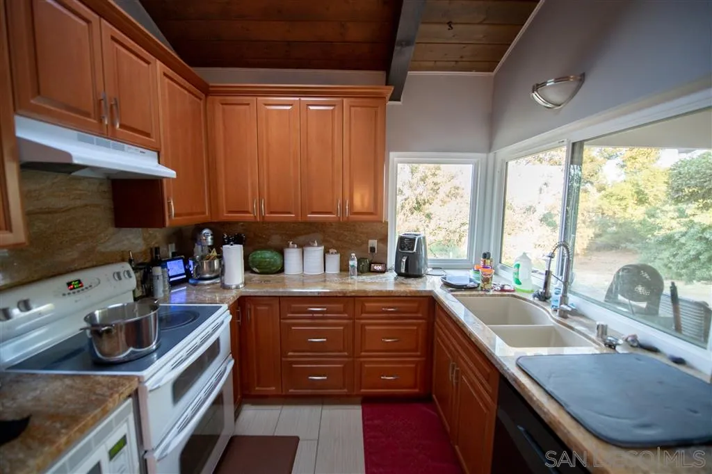 1310 South Grade Road Alpine, CA 91901 - Photo 8 of 18 a kitchen with a sink stove top oven and cabinets