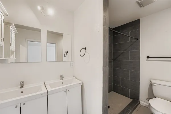 an empty room with a window and a ceiling fan