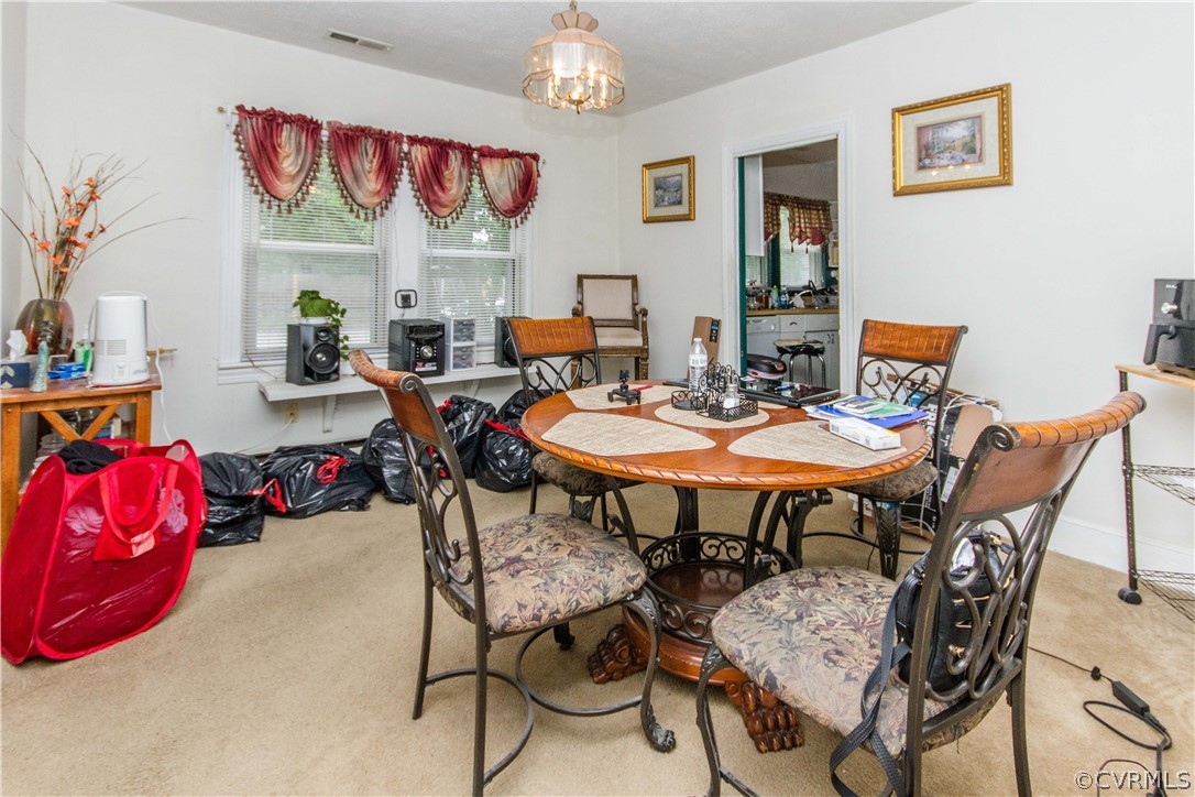 2202 West City Point Road Hopewell, VA 23860 - Photo 7 of 18 a view of a dining room and livingroom with furniture wooden floor and a chandelier