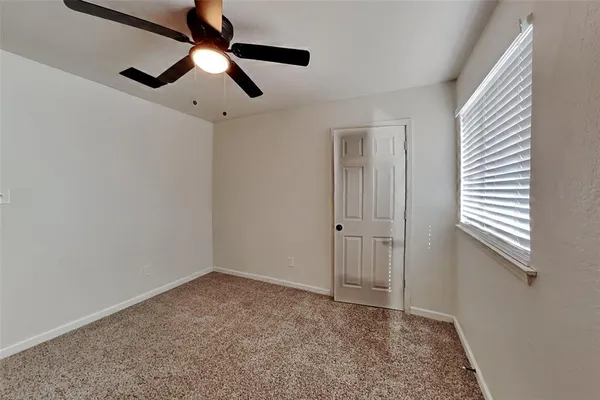 a view of room with window and ceiling fan