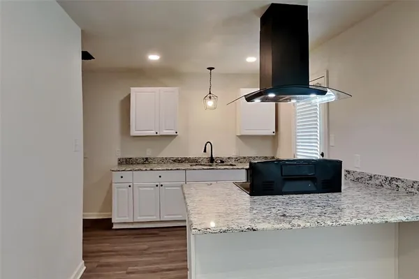 a kitchen with stainless steel appliances granite countertop a sink and a stove
