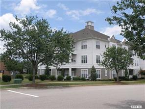 a view of a white house next to a yard and trees