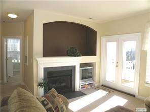 18605 Ruffner Drive, Unit 2B Cornelius, NC 28031 - Photo 4 of 11 a living room with a fireplace and a walk in closet
