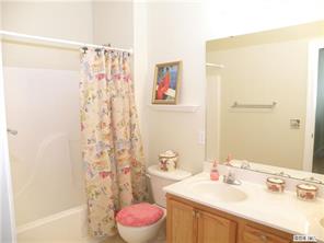 18605 Ruffner Drive, Unit 2B Cornelius, NC 28031 - Photo 7 of 11 a bathroom with a sink mirror vanity and toilet