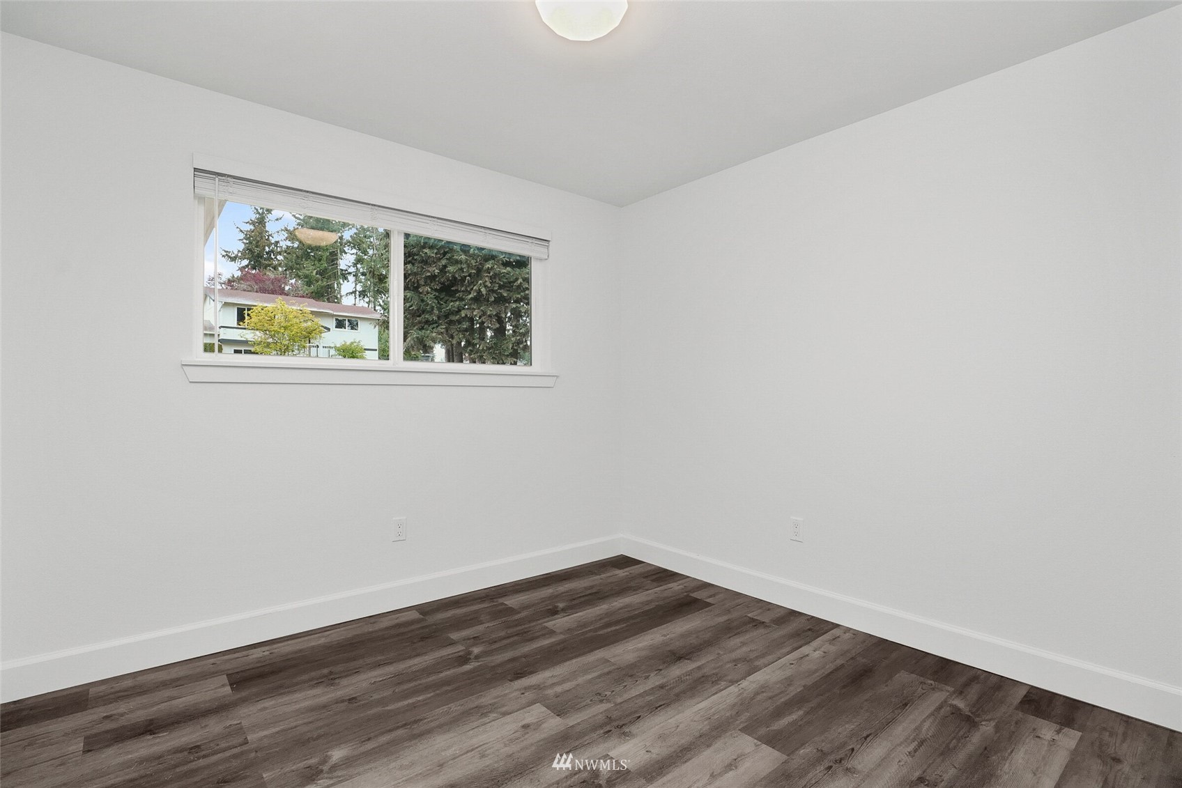 2009 Northeast 24th Street Renton, WA 98056 - Photo 12 of 22 a view of an empty room with wooden floor and a window