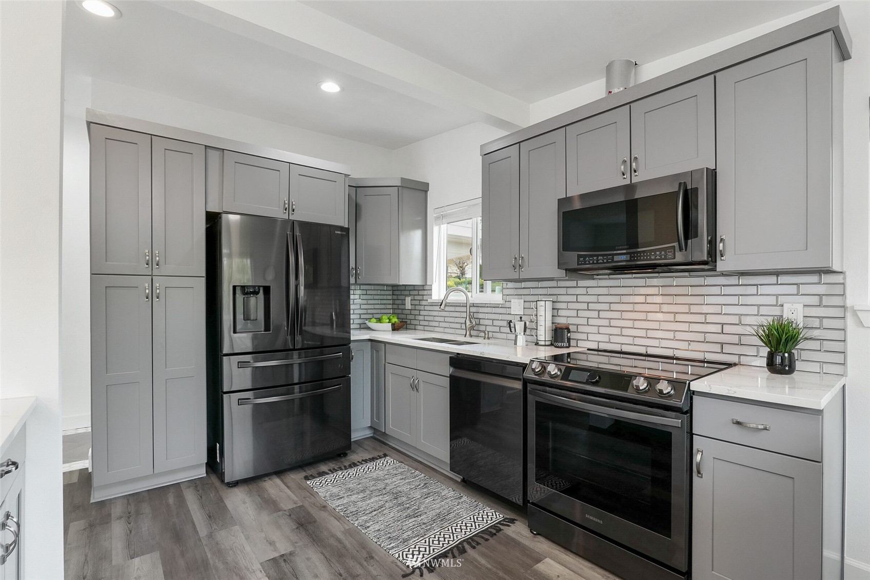 2009 Northeast 24th Street Renton, WA 98056 - Photo 6 of 22 a kitchen with stainless steel appliances a stove sink microwave and refrigerator