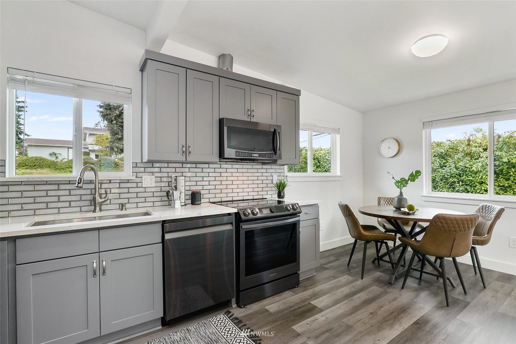 2009 Northeast 24th Street Renton, WA 98056 - Photo 7 of 22 a kitchen with a table chairs sink and cabinets