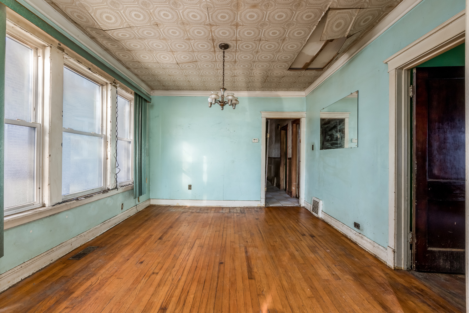 7206 South Lafayette Avenue Chicago, IL 60621 - Photo 7 of 17 a view of a room with wooden floor fan and windows