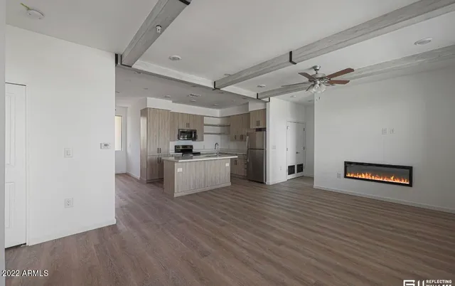 a view of a kitchen with a sink wooden floor and a window