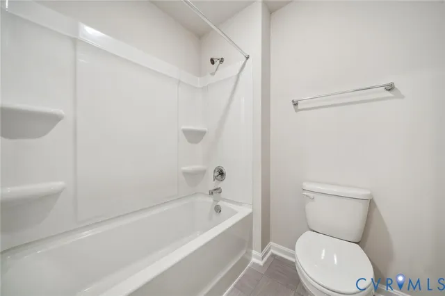 a white toilet sitting next to a bath tub