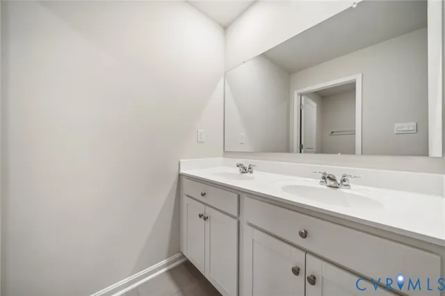 a bathroom with a double vanity sink and mirror