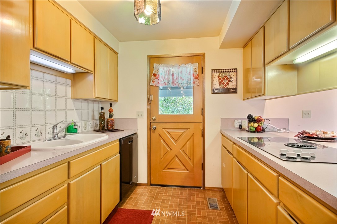20109 Southeast 142nd Street Renton, WA 98059 - Photo 14 of 39 a kitchen with stainless steel appliances a sink stove and cabinets