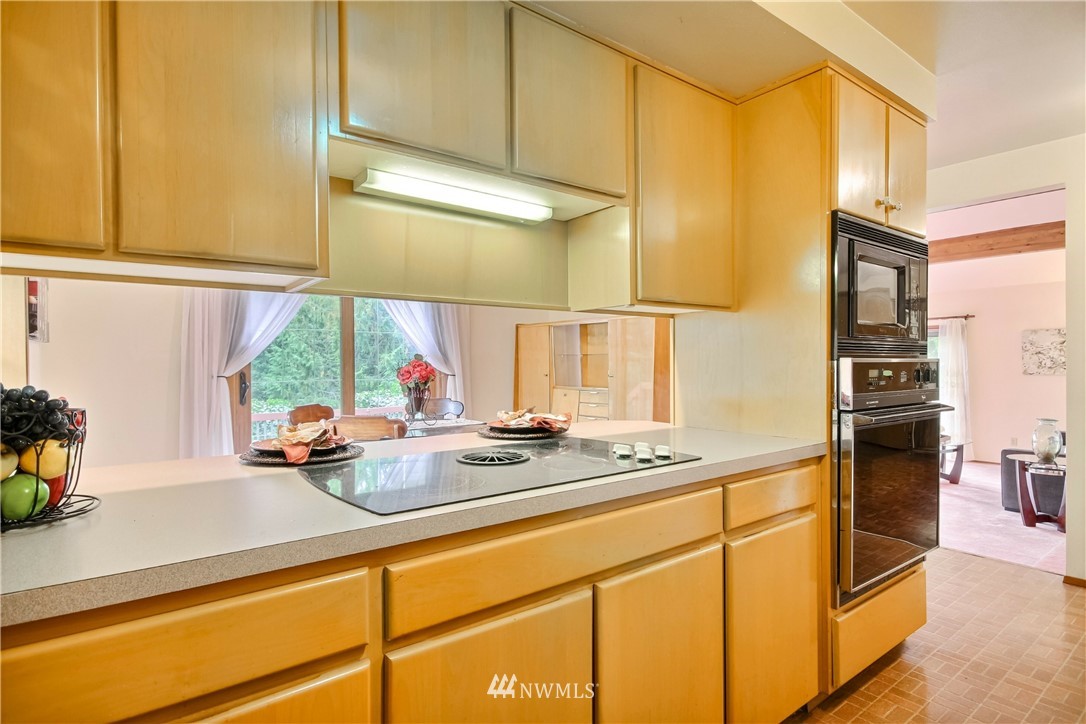20109 Southeast 142nd Street Renton, WA 98059 - Photo 15 of 39 a kitchen with stainless steel appliances granite countertop a sink and a refrigerator