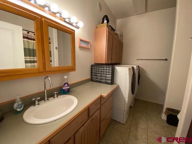 24194 Rd L Cortez, CO 81321 - Photo 14 of 30 a bathroom with a sink toilet and a mirror