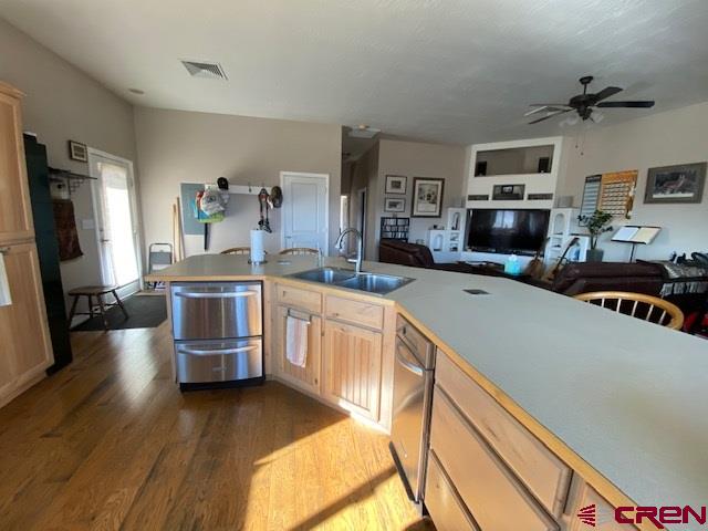 24194 Rd L Cortez, CO 81321 - Photo 15 of 30 a kitchen with stainless steel appliances a stove a sink dishwasher a oven a dining table and chairs with wooden floor