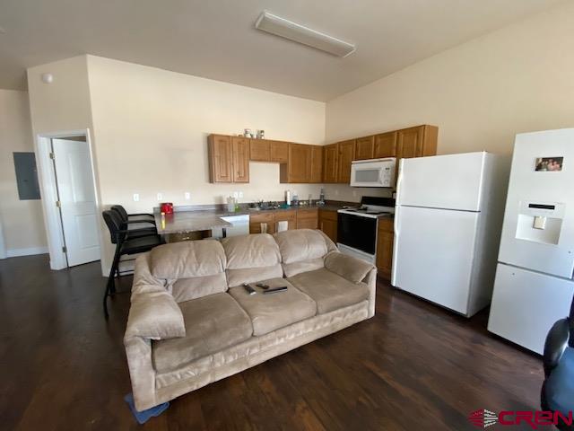 24194 Rd L Cortez, CO 81321 - Photo 16 of 30 a living room with furniture and a refrigerator