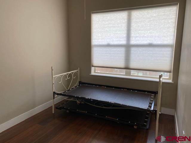 24194 Rd L Cortez, CO 81321 - Photo 20 of 30 a room with wooden floor and a window
