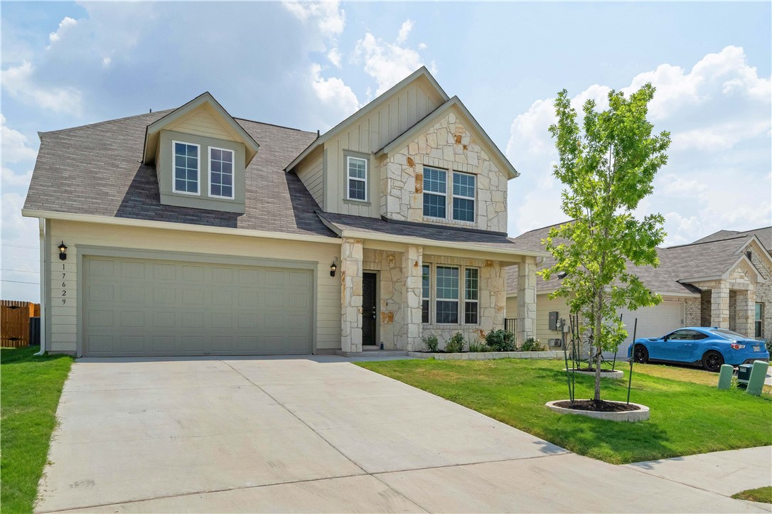 17629 Shafer Drive Pflugerville, TX 78660 - Photo 2 of 35 a front view of a house with a yard and trees